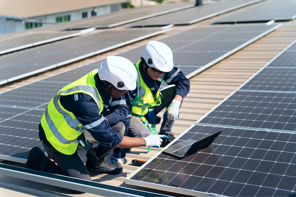 Certified technician installing solar panels on a roof